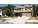 Traditional-style house showcasing a well-maintained lawn, extended driveway, and inviting curb appeal at 120 Park Village Dr, Canton, GA 30114