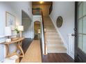 Bright foyer with wood floors, staircase, and natural light creates a welcoming entrance at 120 Park Village Dr, Canton, GA 30114