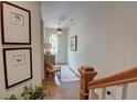Bright foyer with hardwood floors, stairway, decorative lighting, and framed prints at 14 Lochurst Ln # 15, Roswell, GA 30076