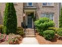 Charming brick home entrance with landscaped garden and stairs to the front door at 14 Lochurst Ln # 153, Roswell, GA 30076