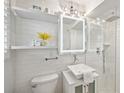 Modern bathroom with an illuminated mirror, a glass-enclosed shower, and white subway tile at 285 Lakemoore Ne Dr # A, Atlanta, GA 30342