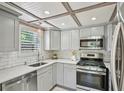 Bright kitchen featuring stainless steel appliances, subway tile backsplash, gray cabinets, and a window at 285 Lakemoore Ne Dr # A, Atlanta, GA 30342