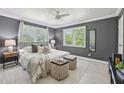 Cozy main bedroom with a ceiling fan, two windows with shutters, and a comfortable bed with decorative pillows at 285 Lakemoore Ne Dr # A, Atlanta, GA 30342