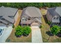 Aerial view of a beautiful two-story home with a well-kept lawn and a two-car garage at 3049 Ivy Crossing Dr, Buford, GA 30519