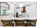 Kitchen showcasing white cabinetry, quartz countertops, marble backsplash, and pendant lighting at 230 Bristolstone Ct, Alpharetta, GA 30005