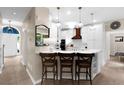 Bright kitchen featuring a breakfast bar with seating and white cabinetry, pendant lighting, and stainless appliances at 230 Bristolstone Ct, Alpharetta, GA 30005