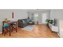 Inviting living room with hardwood floors, gray sofa, natural light, and access to an outdoor patio at 2700 Pine Tree Ne Rd # 1214, Atlanta, GA 30324