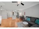 Living room with hardwood floors, a gray sofa, and an open layout to the kitchen area at 2700 Pine Tree Ne Rd # 1214, Atlanta, GA 30324