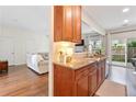 Well-lit kitchen offering wood cabinets, granite countertops, and seamless access to the living space at 3303 Timbercreek Cir, Roswell, GA 30076