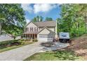 Charming two-story home featuring a front porch and a spacious two-car garage at 745 Beaver Pond Trl, Fairburn, GA 30213
