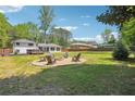 Expansive backyard features a gravel firepit and a charming backdrop, perfect for outdoor gatherings at 2710 Hayden Dr, East Point, GA 30344