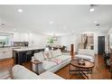 Open-concept living room showcasing hardwood floors, a modern kitchen, and access to dining area at 2710 Hayden Dr, East Point, GA 30344