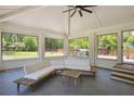 Sunroom with slate tile, white brick accent wall, and backyard views from the large windows at 2710 Hayden Dr, East Point, GA 30344