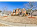 Inviting two-story brick house with well-kept lawn and traditional architectural details at 5447 Stirrup Way, Powder Springs, GA 30127