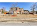 Attractive two-story home on a corner lot with an expansive lawn and tidy landscaping at 5447 Stirrup Way, Powder Springs, GA 30127