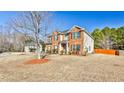 Charming two-story home with a well-maintained lawn and mature trees in a suburban setting at 5447 Stirrup Way, Powder Springs, GA 30127