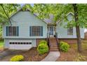 Charming two-story home with light blue siding, blue shutters, and an attached garage at 865 Turner Dr, Lawrenceville, GA 30046