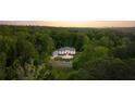 Stunning aerial view of a secluded home surrounded by lush greenery and beautiful landscaping at 5260 Long Island Nw Dr, Atlanta, GA 30327