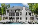 Luxury home with a private pool, outdoor lounge area, and screened-in porch for upscale living at 5260 Long Island Nw Dr, Atlanta, GA 30327