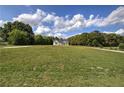 Secluded two-story farmhouse sits majestically on a large, grassy lot with a tree-lined backdrop, offering privacy at 613 Nebo Rd, Dallas, GA 30157