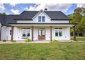 Inviting front porch with wood columns, a porch swing, and double front doors, perfect for relaxing outdoors at 613 Nebo Rd, Dallas, GA 30157