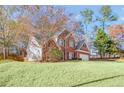 Beautiful home featuring a well-maintained lawn and a classic brick facade at 893 Brookgreen Pl, Lawrenceville, GA 30043