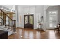 Grand foyer boasts hardwood floors, decorative staircase, and elegant stained glass double-door entrance at 225 Farmbrooke Ct, Sandy Springs, GA 30350