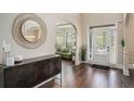 Inviting foyer with hardwood floors, high ceilings, modern decor, and arched doorway at 812 Nevis Way, Mcdonough, GA 30253