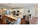 Open concept kitchen with island seating, stainless steel appliances, and an adjoining dining area at 2507 Fairweather Se Ct, Conyers, GA 30013
