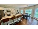 A spacious eat-in kitchen features a large island with bar stool seating and stainless steel appliances at 2507 Fairweather Se Ct, Conyers, GA 30013