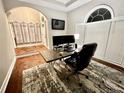 Home office features modern desk, computer setup, and natural light from a large window at 2507 Fairweather Se Ct, Conyers, GA 30013