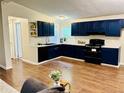 Stylish kitchen featuring sleek, navy blue cabinets, modern appliances, and a seamless flow at 8 Dixie Dr, Stockbridge, GA 30281