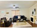 Inviting living room with comfortable sofas, a modern ceiling fan, and an electric fireplace at 8 Dixie Dr, Stockbridge, GA 30281