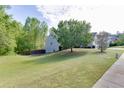 A large backyard with green grass and tree line, providing a spacious and private outdoor area at 1625 Brisbane Dr, Dacula, GA 30019
