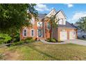 Charming two-story brick home featuring a landscaped yard and an attached two-car garage at 1650 Berryhill Rd, Cumming, GA 30041