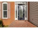 Beautiful front door with decorative glass and brick surround; a charming entry at 1650 Berryhill Rd, Cumming, GA 30041