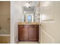 Bathroom with a vanity, large mirror, and built-in shelves next to a bathtub at 57 Forsyth Nw St # 12E, Atlanta, GA 30303