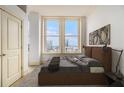 Cozy bedroom with a double window showcasing a city view and a comfortable bed at 57 Forsyth Nw St # 12E, Atlanta, GA 30303