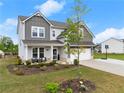 Charming two-story home featuring a well-manicured lawn, two-car garage, and inviting front porch area at 837 Porches Way, Dacula, GA 30019