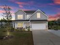 Charming two-story home featuring a well-manicured lawn, two-car garage, and inviting front porch area at 837 Porches Way, Dacula, GA 30019