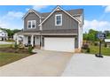 Charming two-story home featuring a well-manicured lawn, two-car garage, and inviting front porch area at 837 Porches Way, Dacula, GA 30019