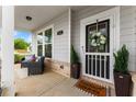 Inviting front porch features a cozy seating area, decorative accents, and a charming entrance at 837 Porches Way, Dacula, GA 30019