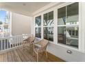 Cozy front porch with wicker chairs, a wood deck, and views of the neighborhood at 919 East Green Ln, Clarkston, GA 30021