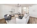 Bright living room with modern decor, hardwood floors, and an open floor plan at 919 East Green Ln, Clarkston, GA 30021