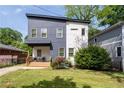 Charming two-story home with a modern design, landscaping, and a welcoming front porch at 210 Locust Ne St, Atlanta, GA 30317