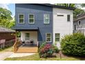 Charming two-story home with a modern design, landscaping, and a welcoming front porch at 210 Locust Ne St, Atlanta, GA 30317