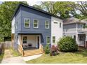 Two-story modern home with a blue and white exterior, landscaped yard, and covered front porch at 210 Locust Ne St, Atlanta, GA 30317