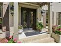 Elegant front entrance featuring double doors with decorative glass inserts and brick steps at 1922 Olde Village Run, Dunwoody, GA 30338