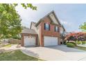 Charming brick and siding home with a well-manicured lawn and a two-car garage at 230 Wild Barley Way, Loganville, GA 30052