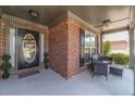 Inviting covered front porch with seating and a view of the landscaped front yard at 230 Wild Barley Way, Loganville, GA 30052